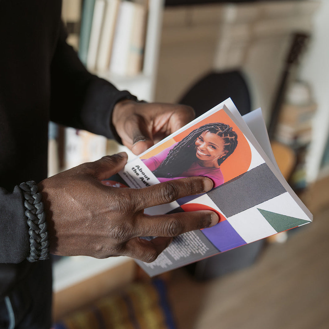 Close-up of a person holding Build It Boldly by Dr. Kimberly McGlonn, showing the author photo on the back cover.