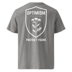 Back view of a heather gray Build It Boldly unisex organic ribbed-neck t-shirt with white “Optimism Protect Yours” shield graphic on a plain background.