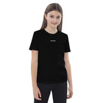 Front view of a black Build It Boldly kids organic cotton t-shirt with small white chest logo on model.