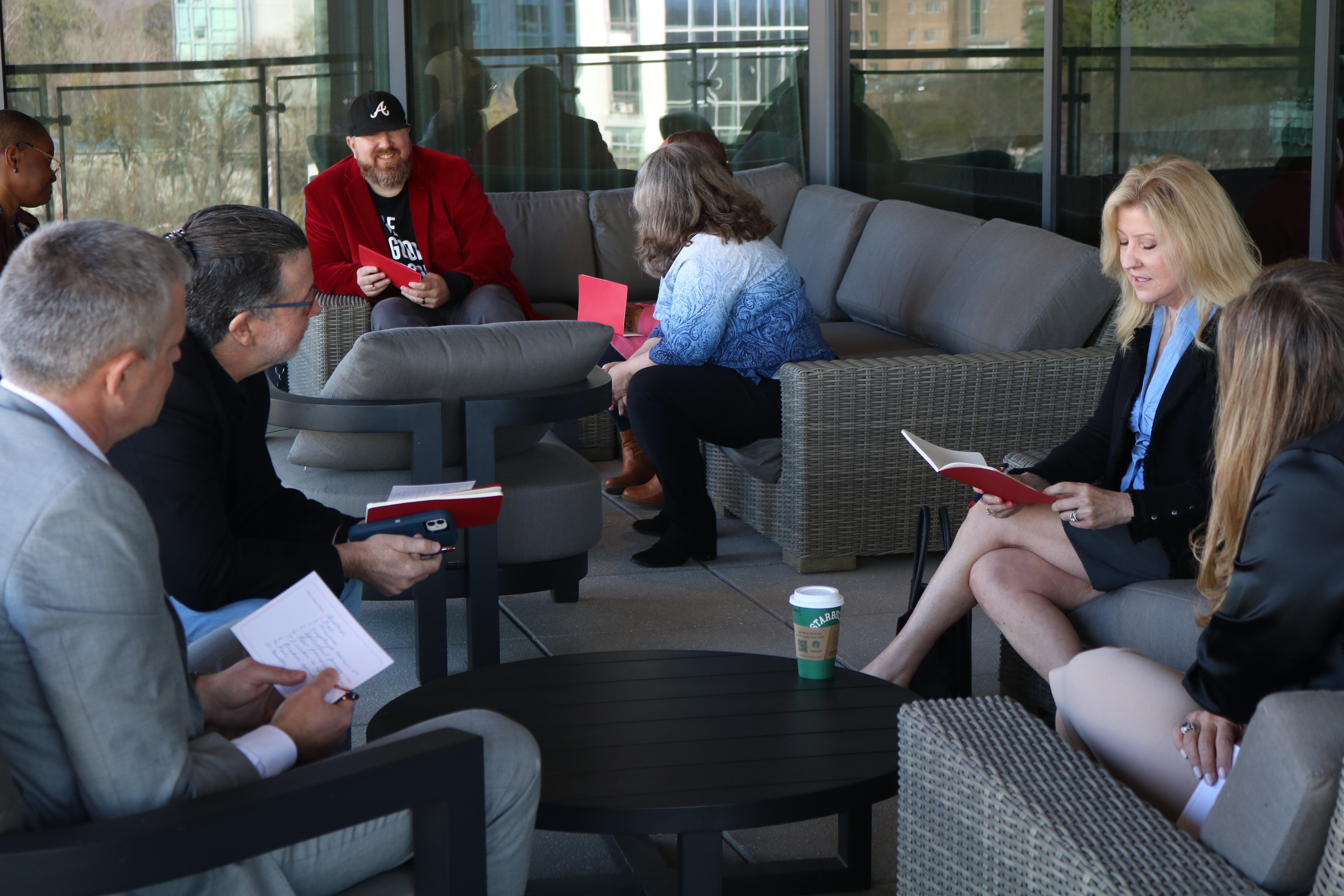Group of professionals discussing leadership ideas together during a Build It Boldly leadership development gathering.