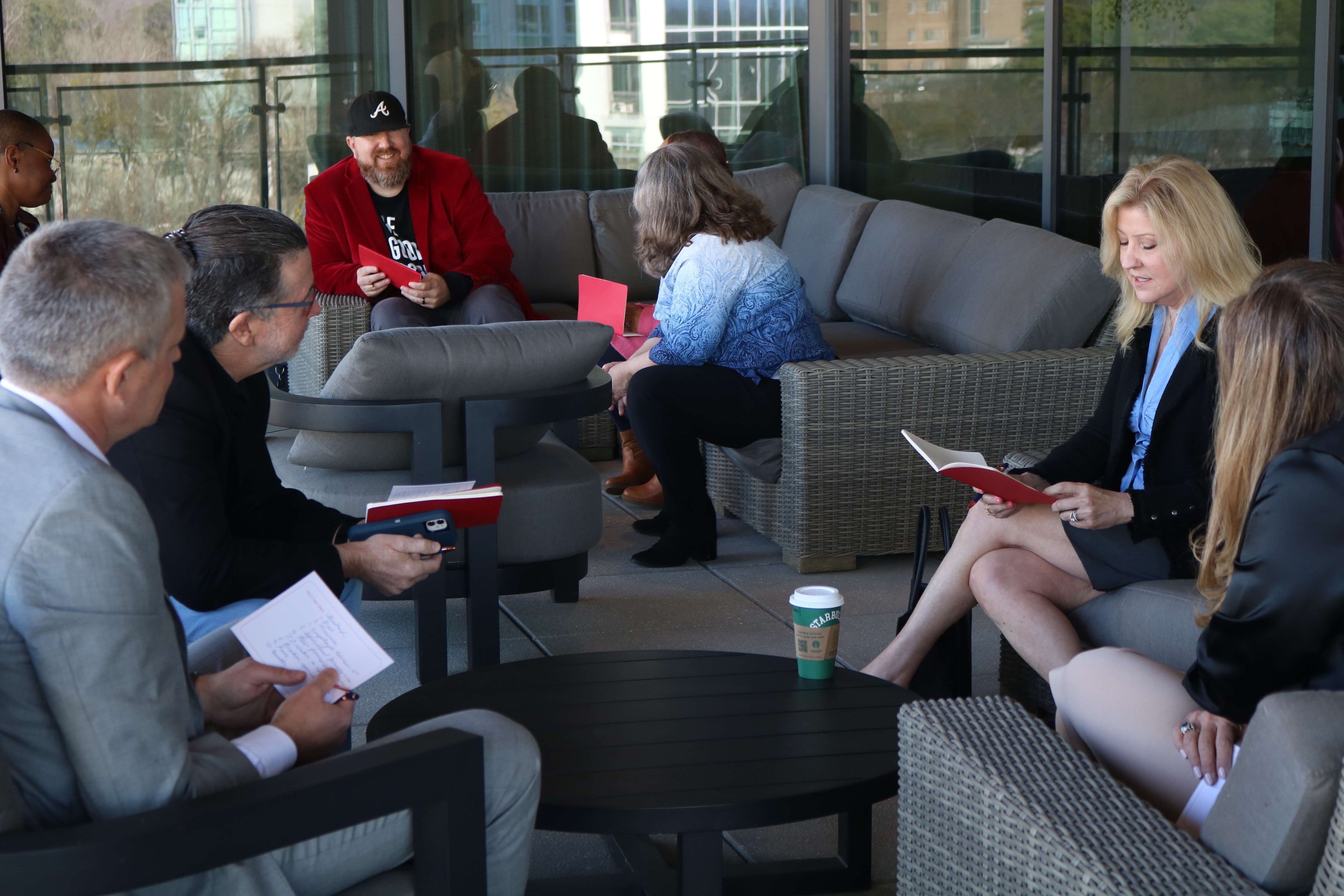 Group of professionals discussing leadership ideas together during a Build It Boldly leadership development gathering.