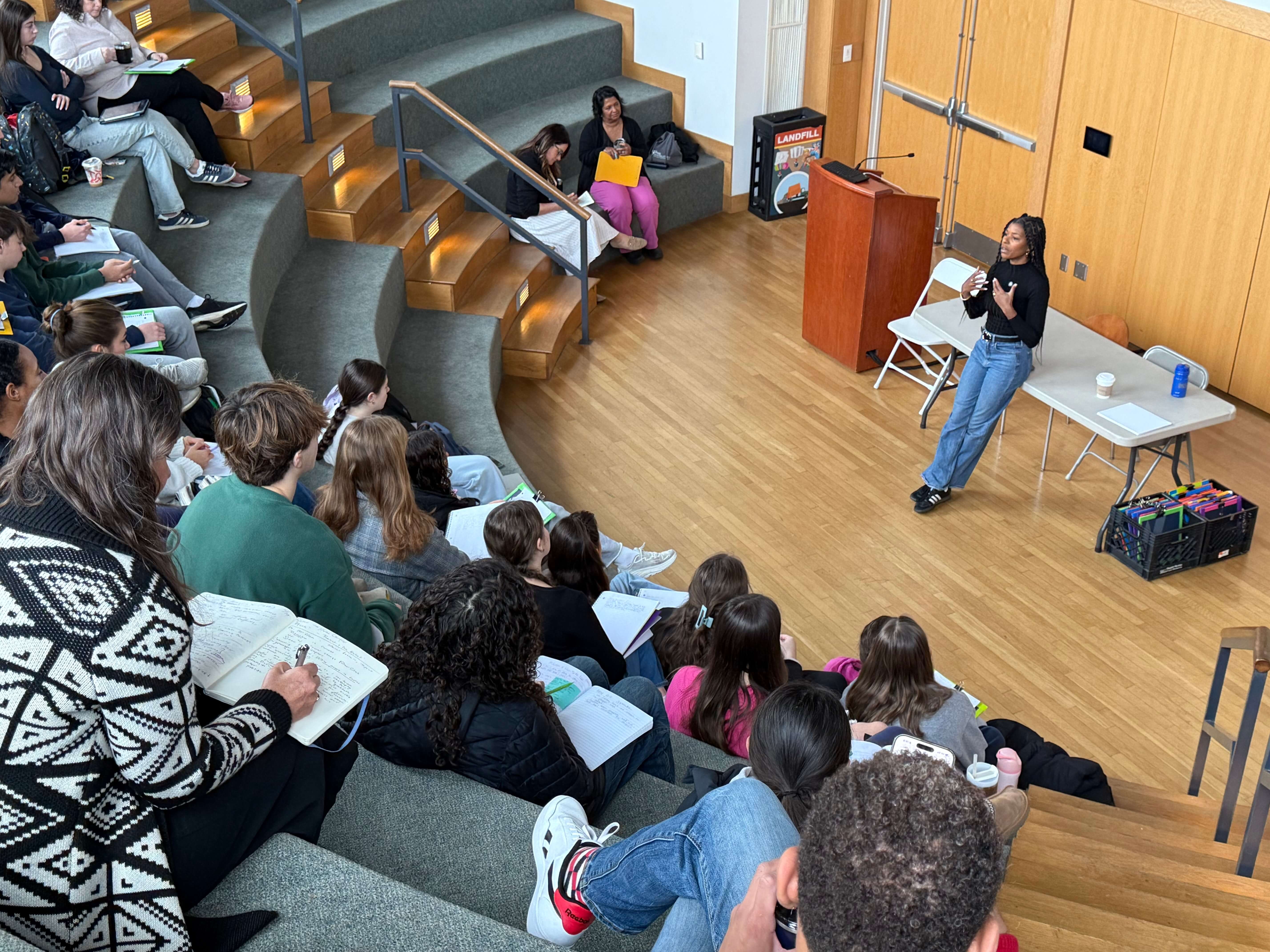 Build It Boldly speaker leading a student leadership workshop in an auditorium while participants take notes.