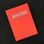 Front cover of The Inner Audit Journal by Build It Boldly on a dark surface, featuring a bold red-orange cover with minimalist typography.