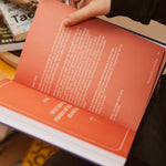 Hand turning a page in The Leader’s Work workbook to a letter from Dr. Kimberly on leadership, clarity, courage, and creating impact through intentional practice.