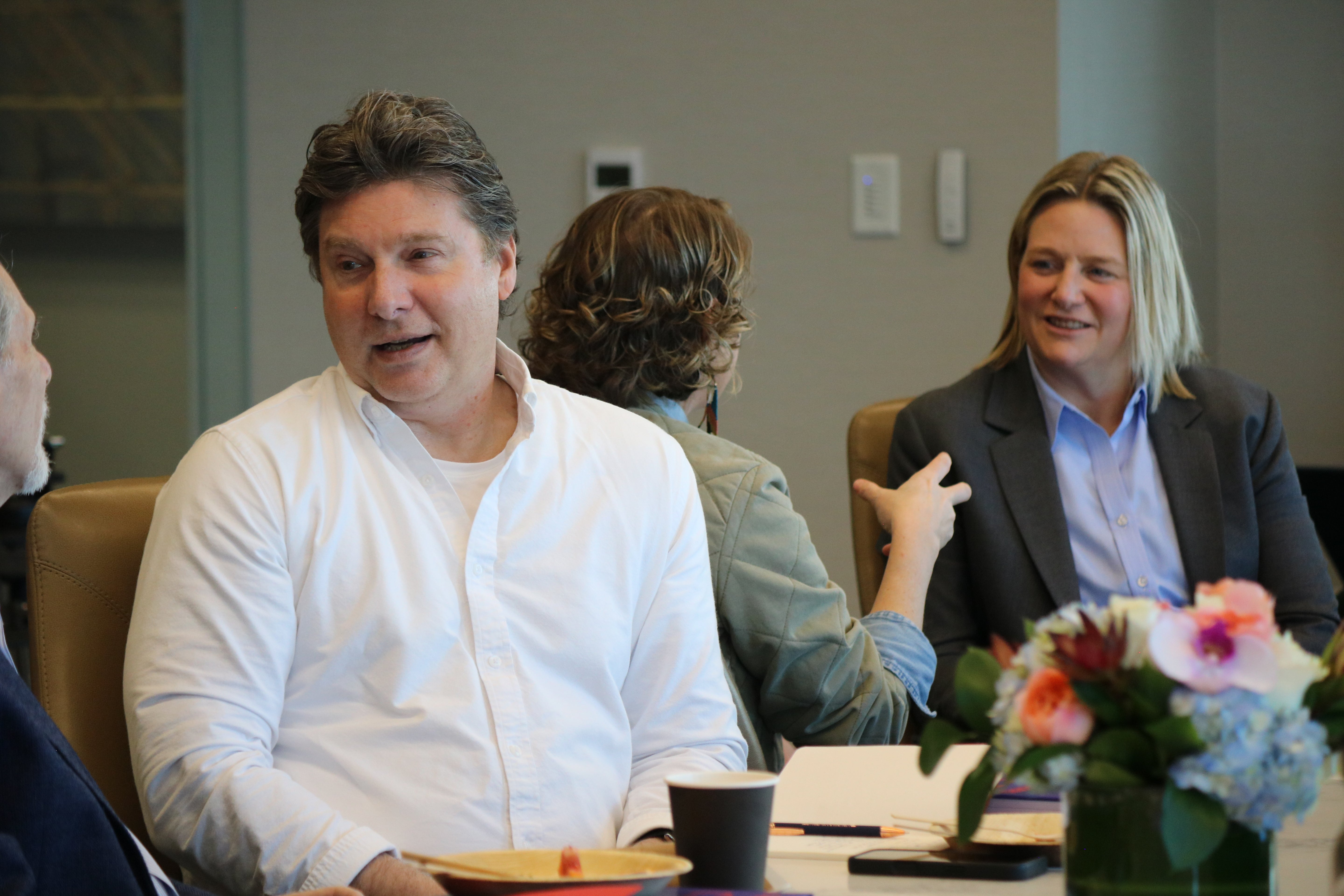 Professionals discussing leadership ideas during a Build It Boldly leadership development session.