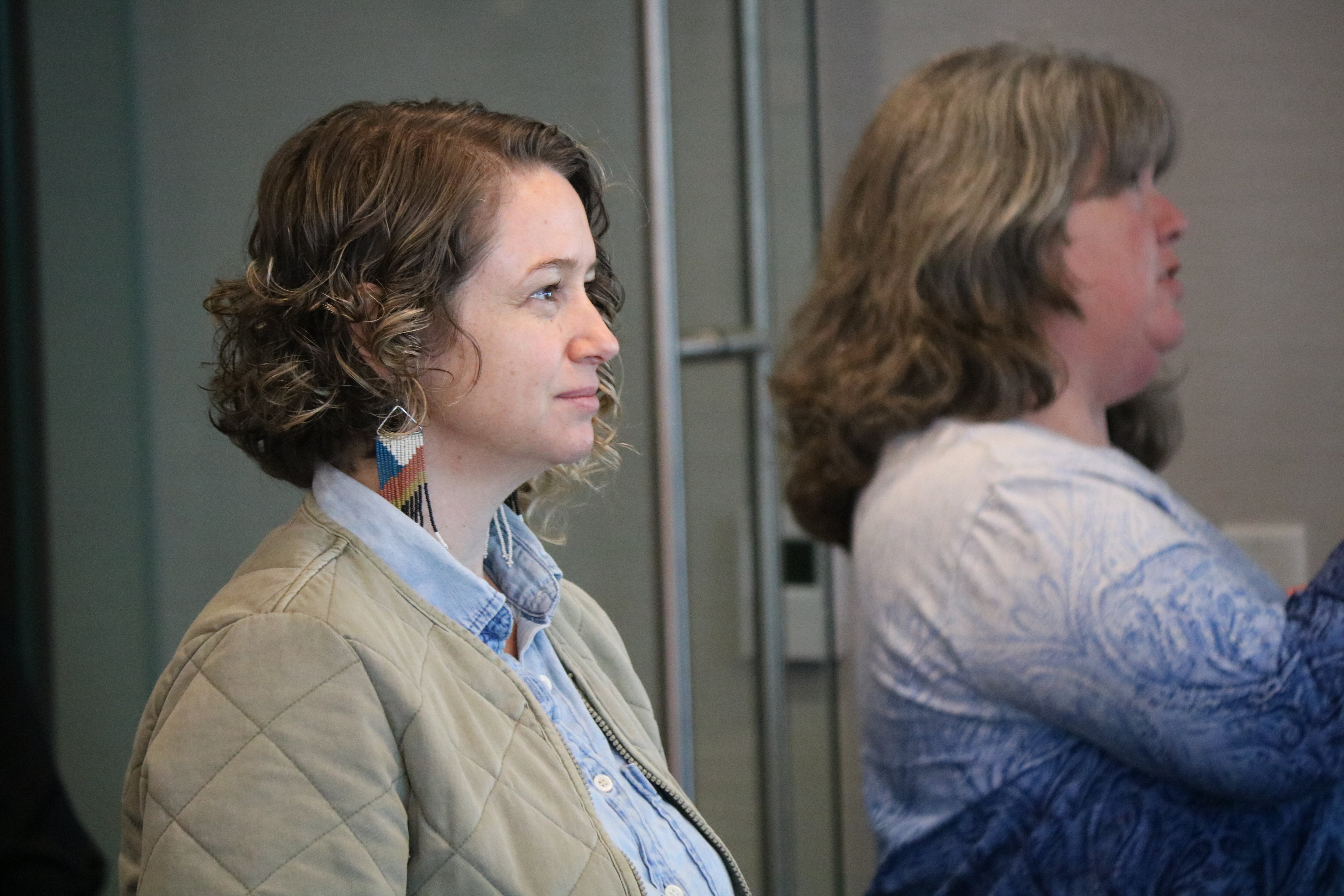 Participant listening attentively during a Build It Boldly leadership workshop discussion.