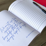 The Leader’s Work workbook open to a guided leadership reflection prompt with a handwritten quote and pen.